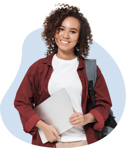 A woman with short, dark curly hair smiles and looks straight at the camera. She is holding a silver laptop and wearing a white t-shirt with a red button-up shirt open over the top and has a gray backpack over her left shoulder.