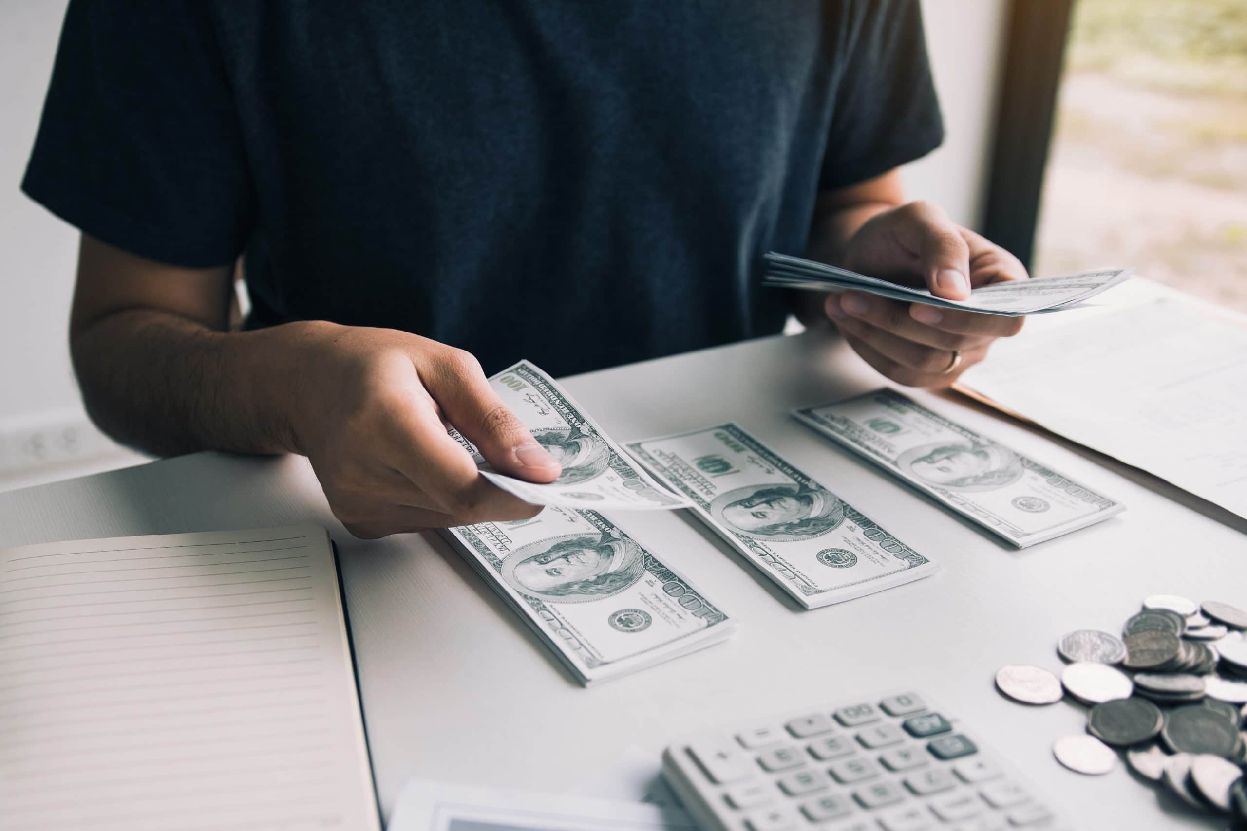 Asian Men Are Holding Banknotes In Cash And Placed On The Table