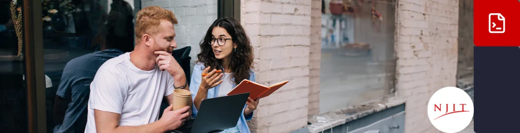 Two people reading a book together outside