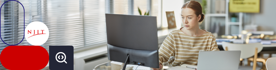 Person in a striped shirt working at a desk with two monitors and a laptop, NJIT logo visible.

