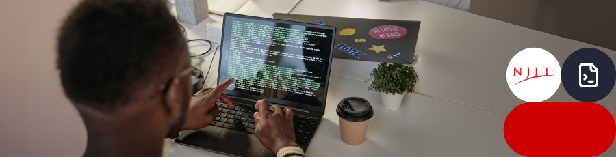 Person working on a laptop with a code editor open, pointing at the screen