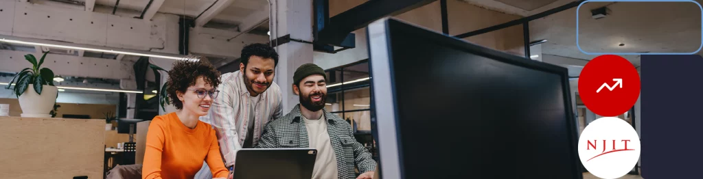 Three people working at computers in an office


