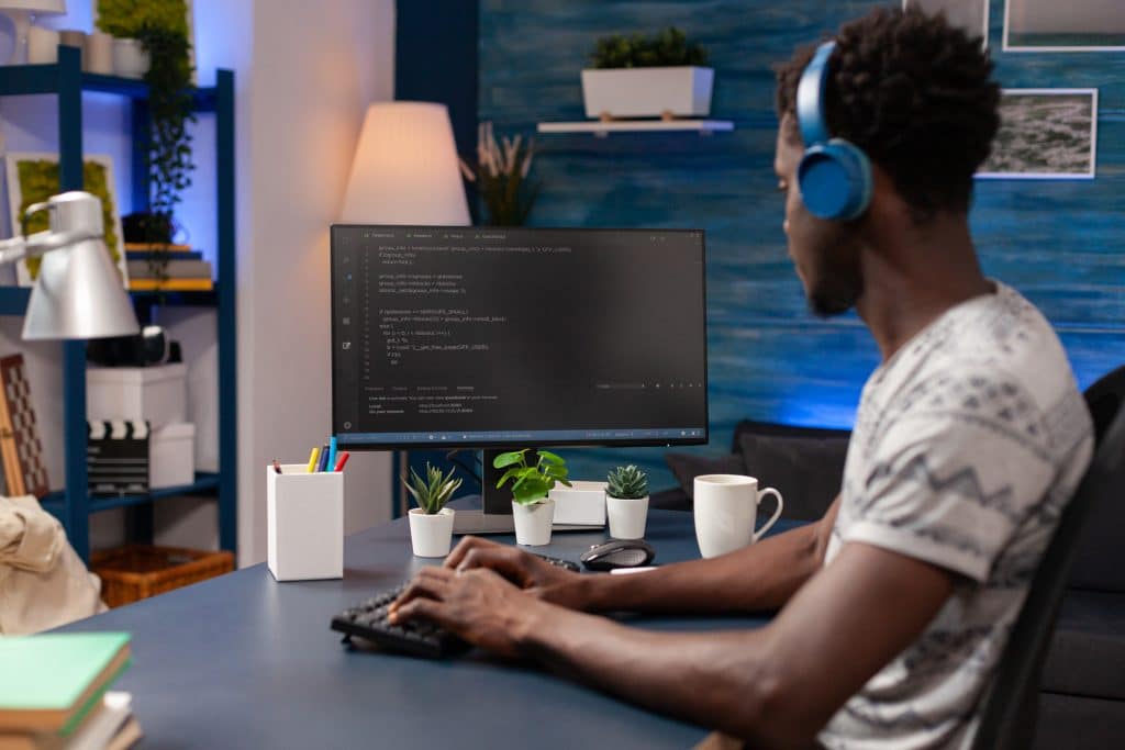 Cybersecurity professional writing code at his computer